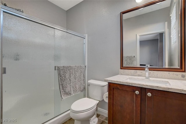 bathroom with toilet, walk in shower, and vanity