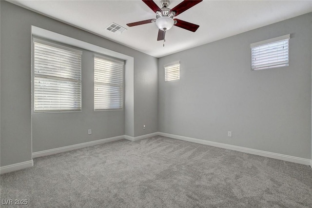 carpeted spare room featuring ceiling fan