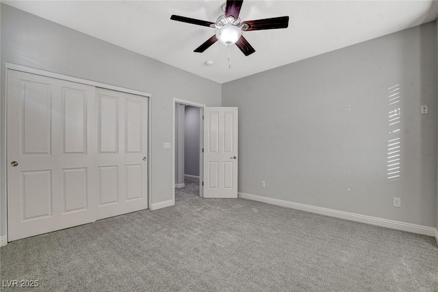 unfurnished bedroom featuring ceiling fan, a closet, and light colored carpet