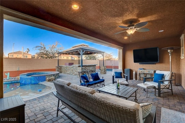 view of patio / terrace with ceiling fan, outdoor lounge area, a pool with hot tub, and a bar