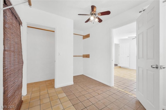 unfurnished bedroom featuring ceiling fan, light tile patterned floors, and a closet