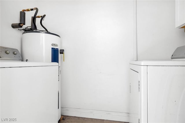 laundry area with washer and clothes dryer and electric water heater