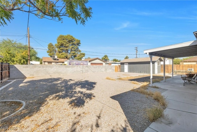 view of yard featuring a patio area and a storage unit