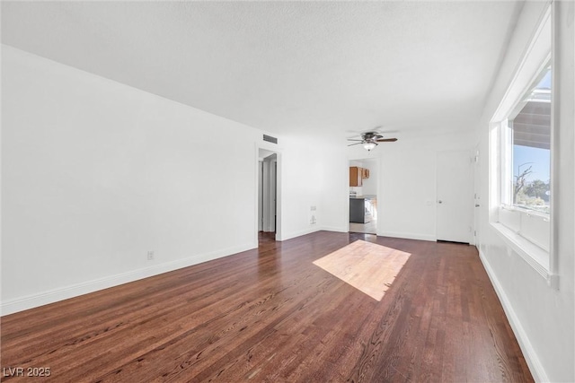 unfurnished living room featuring ceiling fan and dark hardwood / wood-style floors