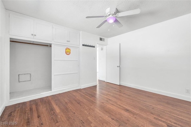 unfurnished room featuring a textured ceiling, ceiling fan, and hardwood / wood-style flooring