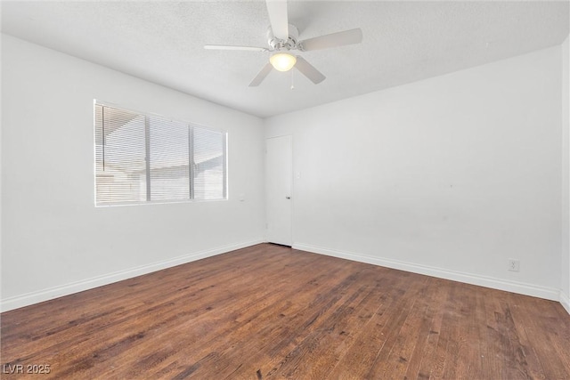 empty room featuring ceiling fan and dark hardwood / wood-style floors