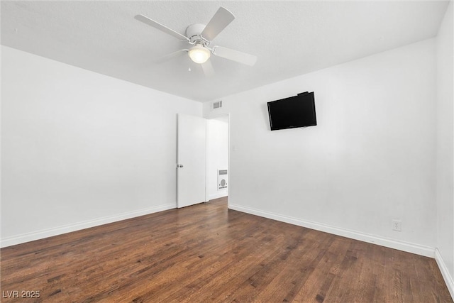 unfurnished room featuring ceiling fan and dark hardwood / wood-style flooring