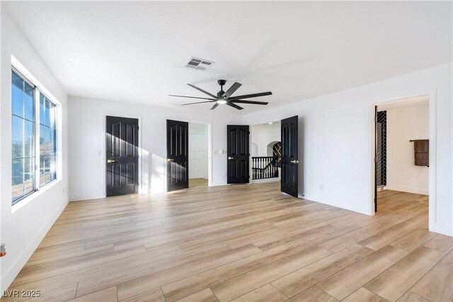 unfurnished room with light wood-type flooring and ceiling fan