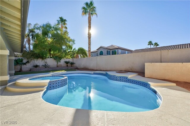 view of swimming pool featuring an in ground hot tub