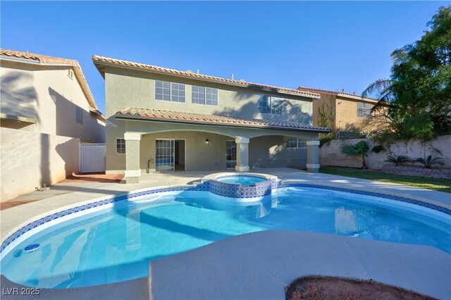 view of pool with a patio area and an in ground hot tub