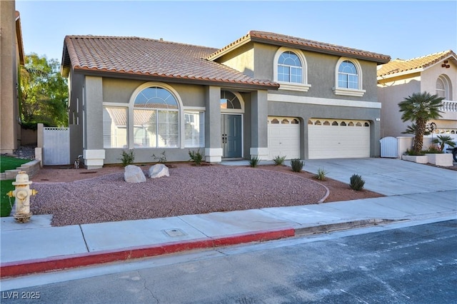 mediterranean / spanish home with a garage