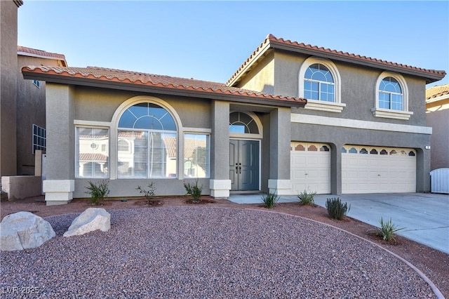 mediterranean / spanish-style house with a garage