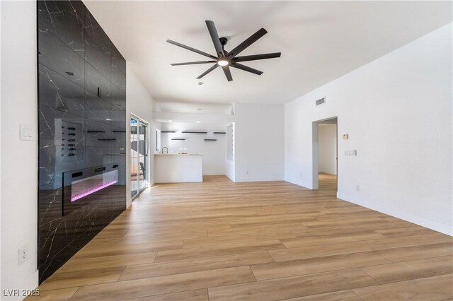 unfurnished living room featuring ceiling fan