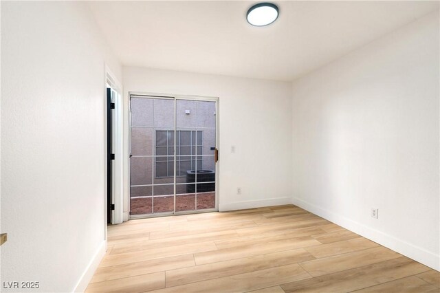 unfurnished room with light wood-type flooring