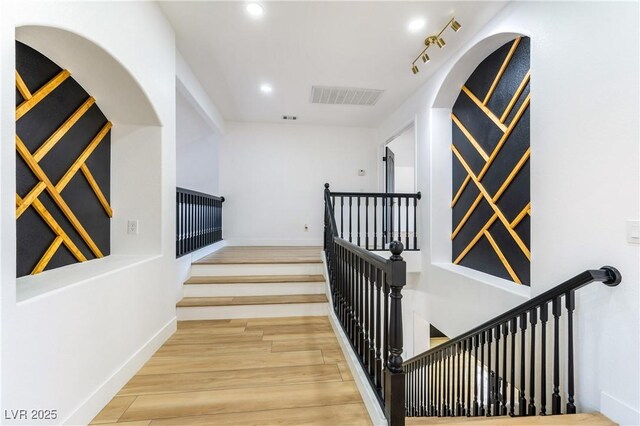 staircase featuring hardwood / wood-style flooring