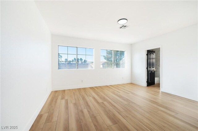 spare room featuring light hardwood / wood-style floors