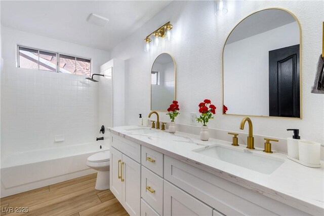 full bathroom with toilet, tiled shower / bath combo, and vanity