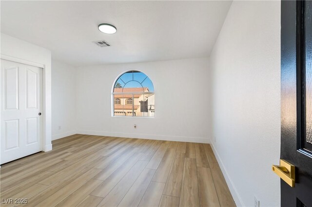 spare room featuring light hardwood / wood-style flooring