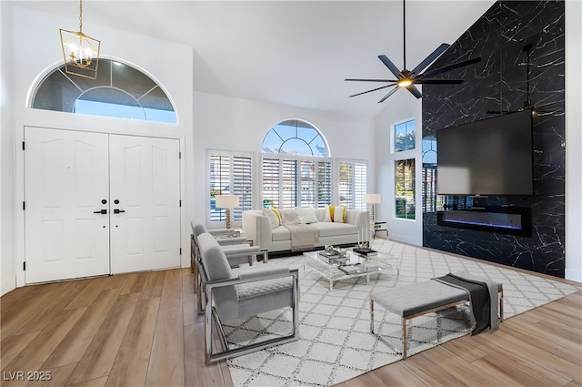 living room featuring high vaulted ceiling, ceiling fan, and hardwood / wood-style floors