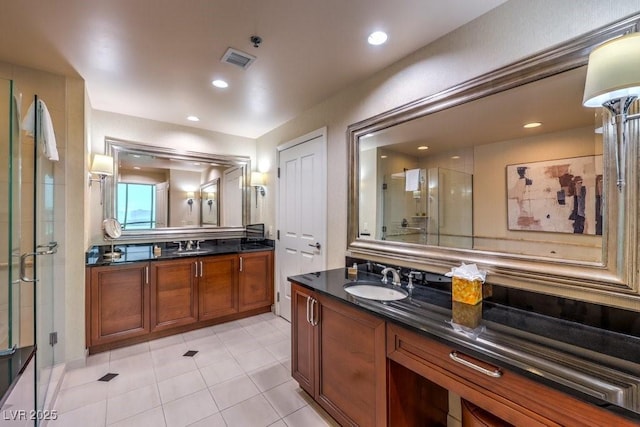 bathroom with vanity, tile patterned floors, and a shower with door