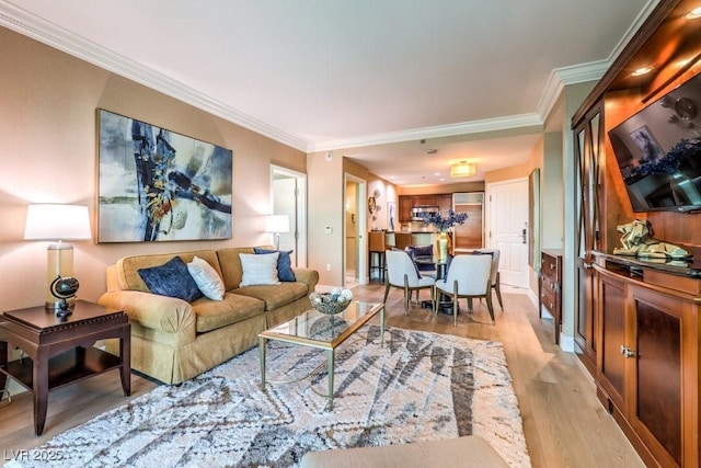 living room with crown molding and light hardwood / wood-style flooring