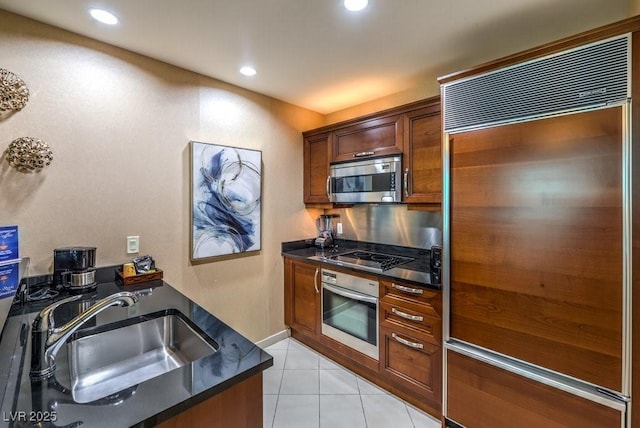 kitchen with light tile patterned floors, sink, and stainless steel appliances