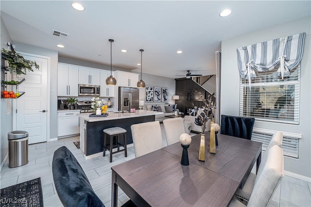 dining space featuring ceiling fan