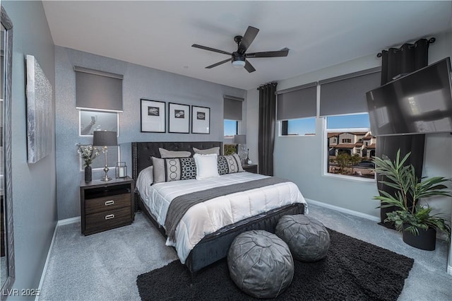 bedroom with ceiling fan and light carpet