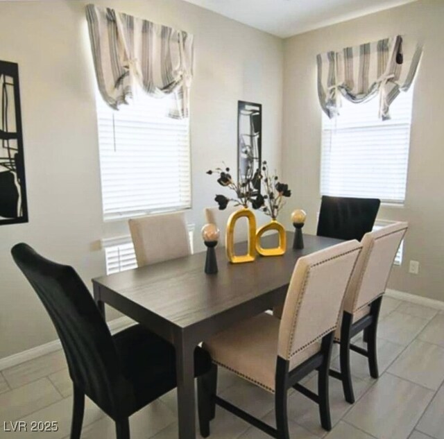 dining area featuring light tile patterned floors and a wealth of natural light