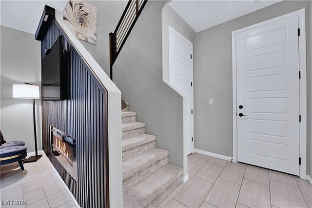 stairway featuring tile patterned flooring