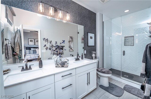 bathroom featuring tile patterned floors, a shower with door, toilet, and vanity