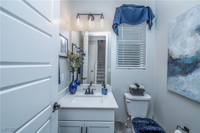 bathroom with toilet and vanity