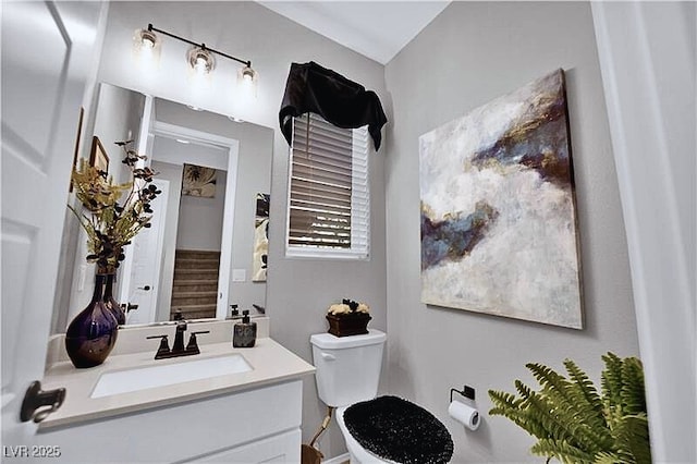 bathroom with toilet and vanity