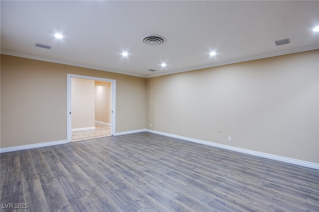 empty room with wood-type flooring and crown molding