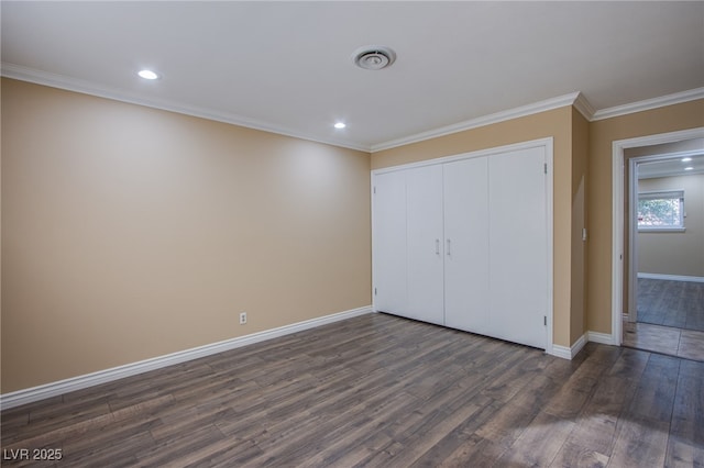 unfurnished bedroom featuring a closet, crown molding, and dark hardwood / wood-style floors