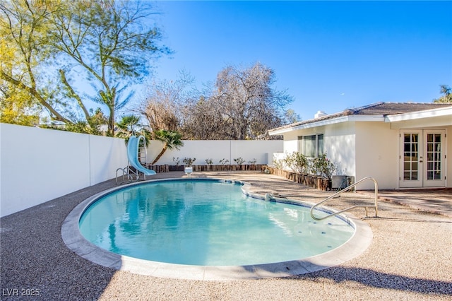 view of swimming pool featuring a patio area and a water slide