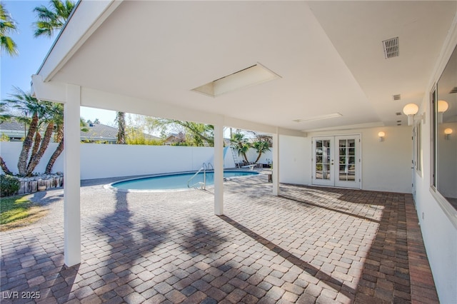 view of swimming pool with a patio area and french doors