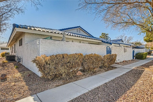 view of side of home featuring cooling unit