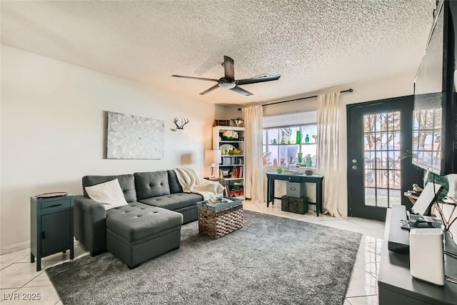 tiled living room featuring ceiling fan and a textured ceiling