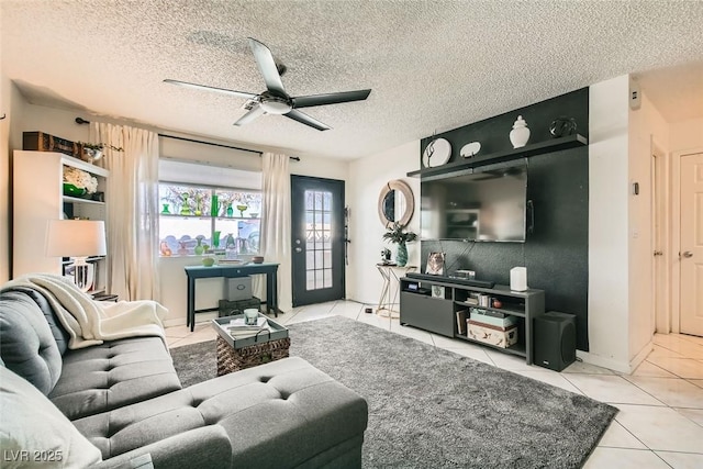 living room with a textured ceiling, ceiling fan, and light tile patterned flooring