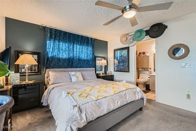 bedroom featuring ceiling fan, a textured ceiling, carpet, and ensuite bath