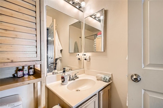 bathroom featuring toilet and vanity