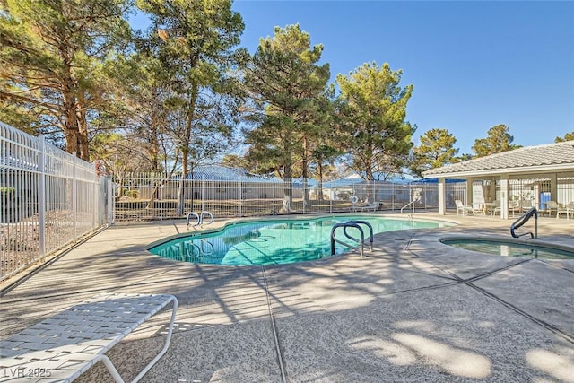 view of pool featuring a patio area and a community hot tub