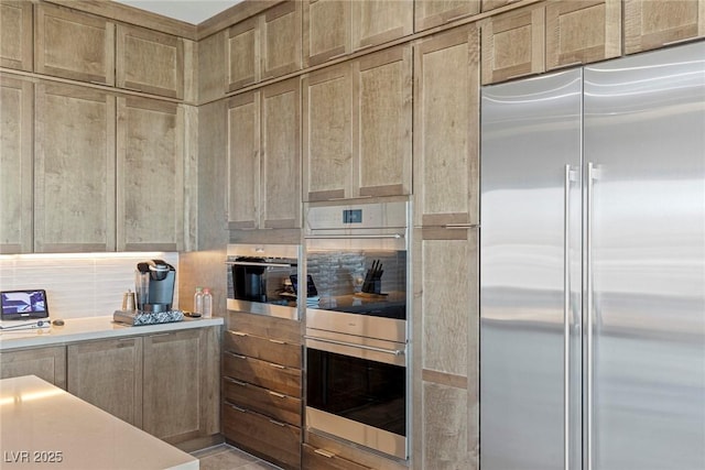 kitchen with decorative backsplash and appliances with stainless steel finishes