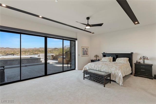 bedroom with access to outside, ceiling fan, light carpet, and a mountain view