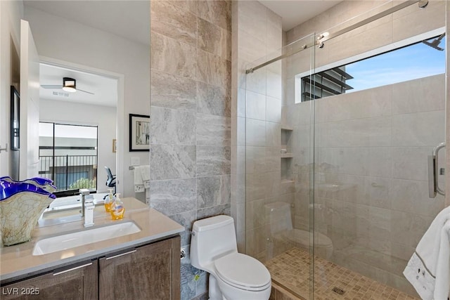 bathroom with ceiling fan, an enclosed shower, vanity, and toilet