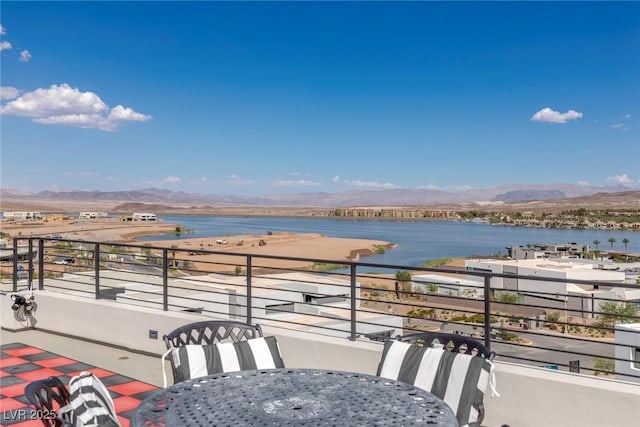 balcony featuring a water and mountain view