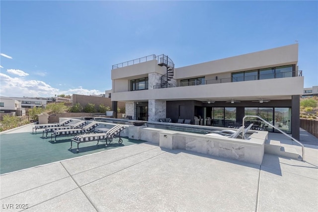 view of swimming pool featuring ceiling fan and a patio