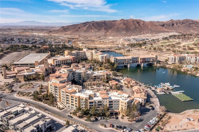 drone / aerial view featuring a water and mountain view