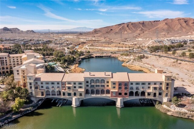 drone / aerial view with a water and mountain view